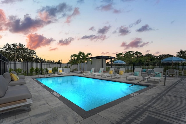 6206 64th Way N, Pinellas Park, FL 33781 - pool at dusk with a patio area and a community pool