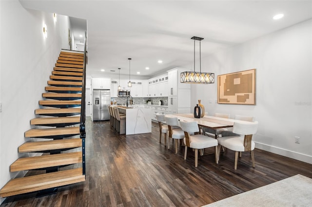 6206 64th Way N, Pinellas Park, FL 33781 - dining room featuring dark wood finished floors, stairway, and recessed lighting