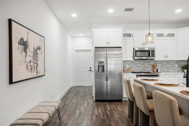 6206 64th Way N, Pinellas Park, FL 33781 - kitchen with appliances with stainless steel finishes, light countertops, glass insert cabinets, backsplash, and dark wood-style flooring