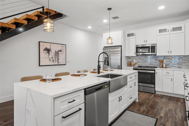 6206 64th Way N, Pinellas Park, FL 33781 - kitchen with appliances with stainless steel finishes, dark wood-type flooring, decorative backsplash, light stone countertops, and glass insert cabinets