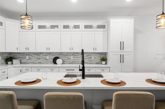 6206 64th Way N, Pinellas Park, FL 33781 - kitchen featuring a kitchen breakfast bar, backsplash, hanging light fixtures, white cabinetry, and recessed lighting
