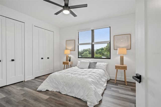 6206 64th Way N, Pinellas Park, FL 33781 - bedroom featuring two closets, wood finished floors, and a ceiling fan