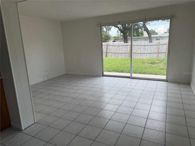 8801 Orange Blossom Dr, Seminole, FL 33772 - unfurnished room featuring light tile patterned floors and baseboards