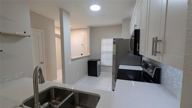 1247 Kennewick Ct, Wesley Chapel, FL 33543 - kitchen featuring appliances with stainless steel finishes, white cabinets, light countertops, and light tile patterned flooring