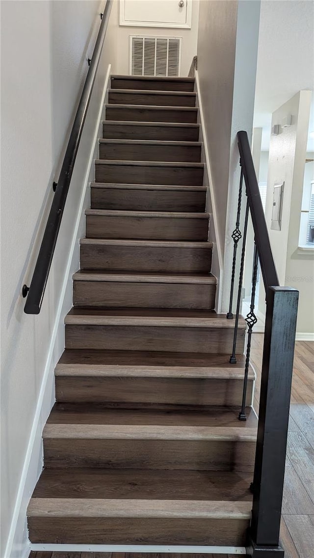 1247 Kennewick Ct, Wesley Chapel, FL 33543 - stairs featuring wood finished floors and baseboards