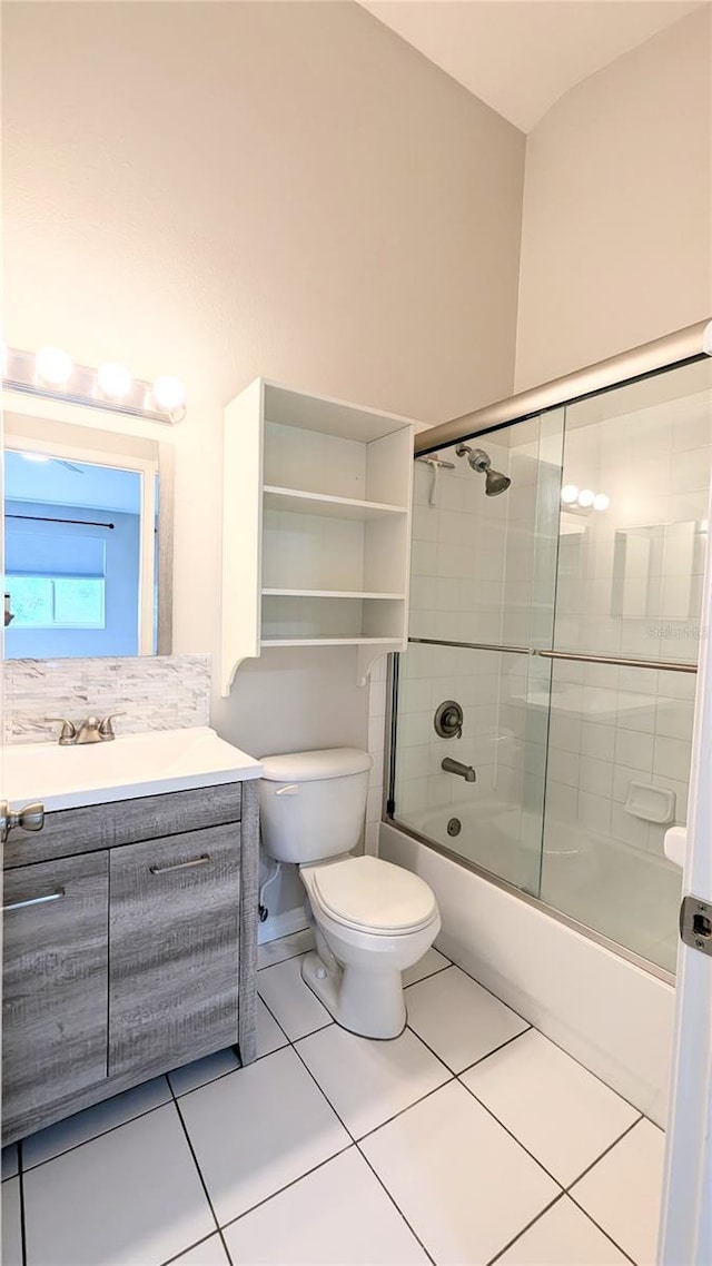 1247 Kennewick Ct, Wesley Chapel, FL 33543 - bathroom featuring combined bath / shower with glass door, vanity, and tile patterned floors