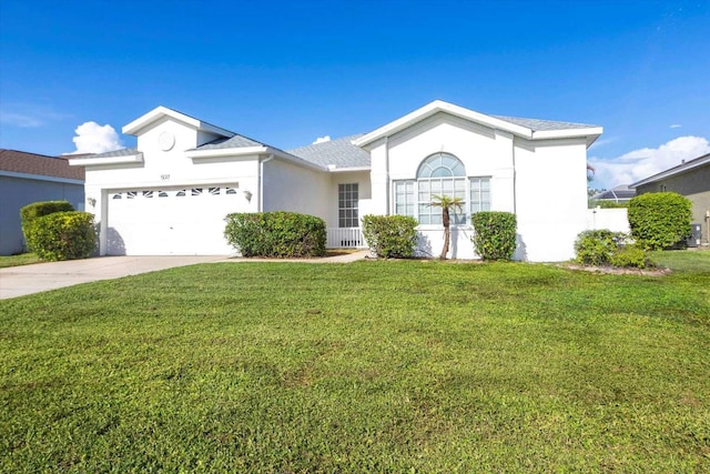 5017 46th St W, Bradenton, FL 34210 - ranch-style home featuring an attached garage, stucco siding, a front lawn, concrete driveway, and roof with shingles