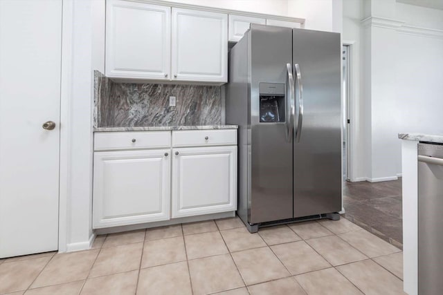 5017 46th St W, Bradenton, FL 34210 - kitchen with appliances with stainless steel finishes, white cabinetry, backsplash, and light stone countertops