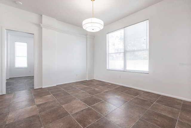 5017 46th St W, Bradenton, FL 34210 - unfurnished room featuring dark tile patterned floors and a smoke detector