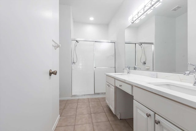 5017 46th St W, Bradenton, FL 34210 - full bathroom with double vanity, a stall shower, tile patterned flooring, and recessed lighting