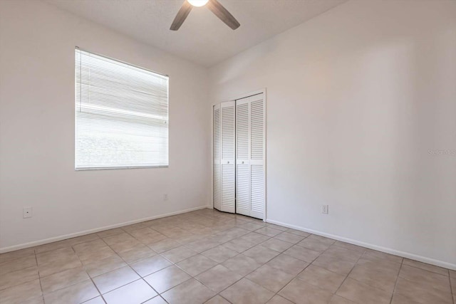 5017 46th St W, Bradenton, FL 34210 - unfurnished bedroom featuring a closet, light tile patterned floors, and a ceiling fan