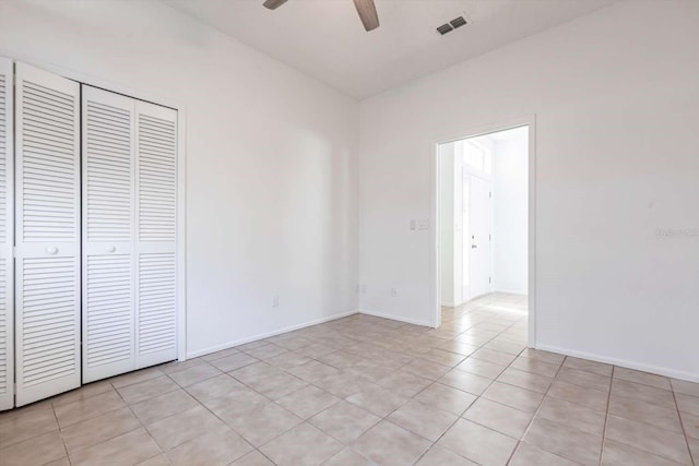 5017 46th St W, Bradenton, FL 34210 - unfurnished bedroom featuring light tile patterned flooring, a closet, and ceiling fan