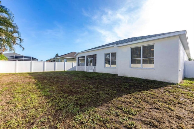 5017 46th St W, Bradenton, FL 34210 - back of house featuring stucco siding and a sunroom