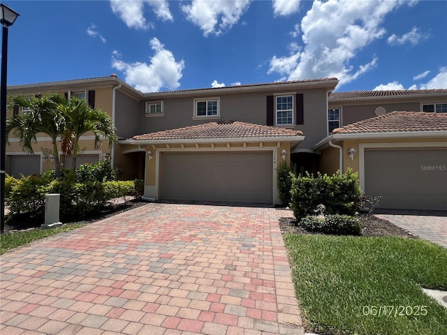 3724 Crofton Ct, Fort Myers, FL 33916 - view of front of house with stucco siding, decorative driveway, a garage, and a tile roof