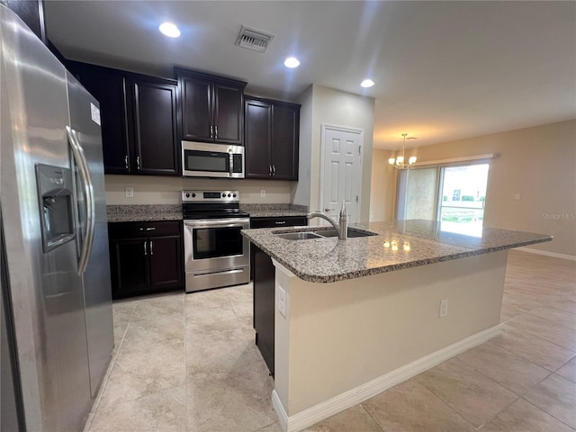3724 Crofton Ct, Fort Myers, FL 33916 - kitchen featuring stainless steel appliances, a chandelier, light stone counters, a center island with sink, and recessed lighting