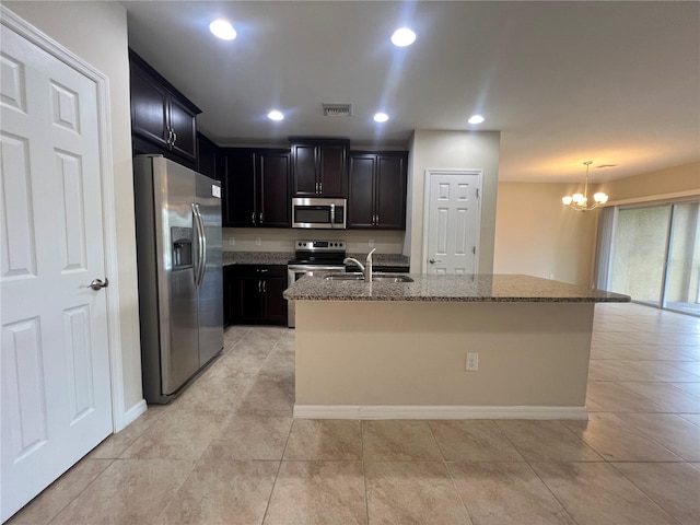 3724 Crofton Ct, Fort Myers, FL 33916 - kitchen featuring stainless steel appliances, a chandelier, stone counters, light tile patterned floors, and dark cabinets