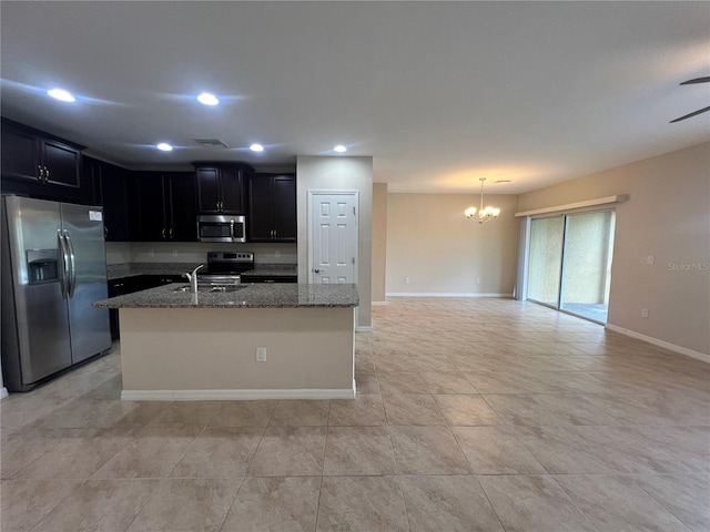 3724 Crofton Ct, Fort Myers, FL 33916 - kitchen with appliances with stainless steel finishes, dark cabinetry, a chandelier, stone counters, and open floor plan