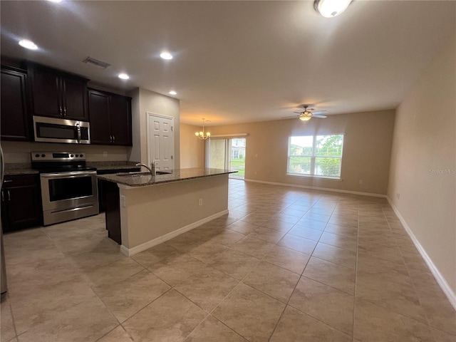 3724 Crofton Ct, Fort Myers, FL 33916 - kitchen with appliances with stainless steel finishes, open floor plan, ceiling fan, dark stone counters, and a chandelier