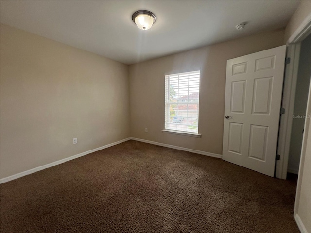 3724 Crofton Ct, Fort Myers, FL 33916 - unfurnished room featuring dark colored carpet and a smoke detector