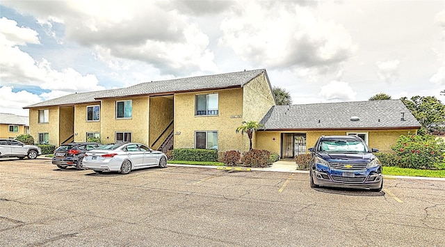4215 E Bay Dr Unit 1706A, Clearwater, FL 33764 - view of property with uncovered parking and stucco siding