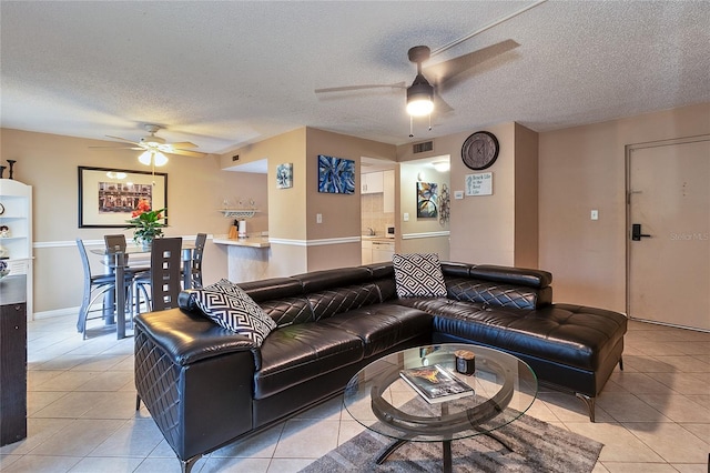 4215 E Bay Dr Unit 1706A, Clearwater, FL 33764 - living room with a ceiling fan, light tile patterned floors, and a textured ceiling