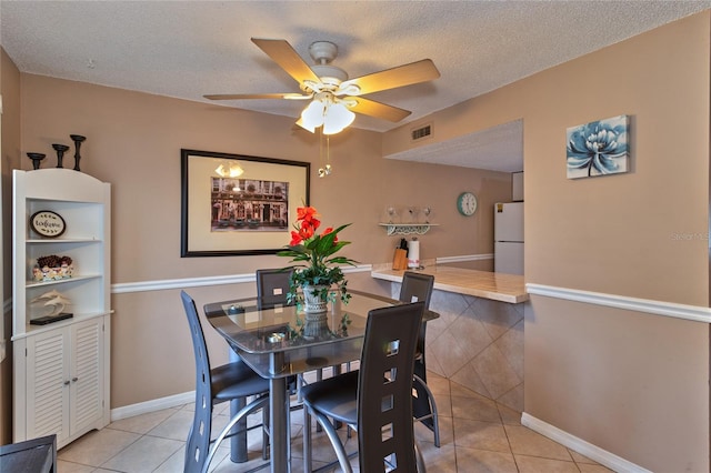 4215 E Bay Dr Unit 1706A, Clearwater, FL 33764 - dining area featuring tile patterned flooring, ceiling fan, and a textured ceiling
