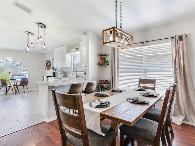 24811 Gun Smoke Dr, Land O Lakes, FL 34639 - dining area with a chandelier and dark wood finished floors