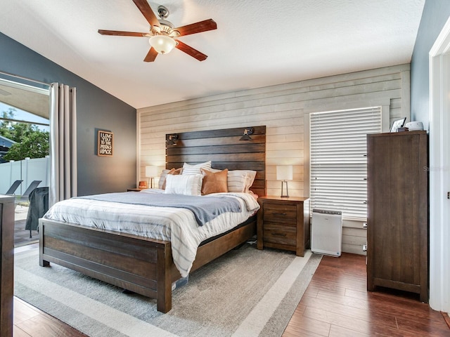 24811 Gun Smoke Dr, Land O Lakes, FL 34639 - bedroom featuring wood finished floors, lofted ceiling, access to outside, a ceiling fan, and wood walls