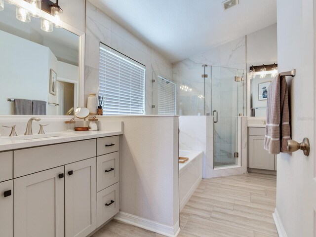 24811 Gun Smoke Dr, Land O Lakes, FL 34639 - bathroom featuring vanity, a bath, a stall shower, and vaulted ceiling