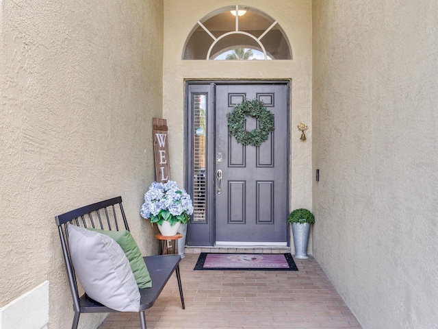 24811 Gun Smoke Dr, Land O Lakes, FL 34639 - doorway to property with stucco siding