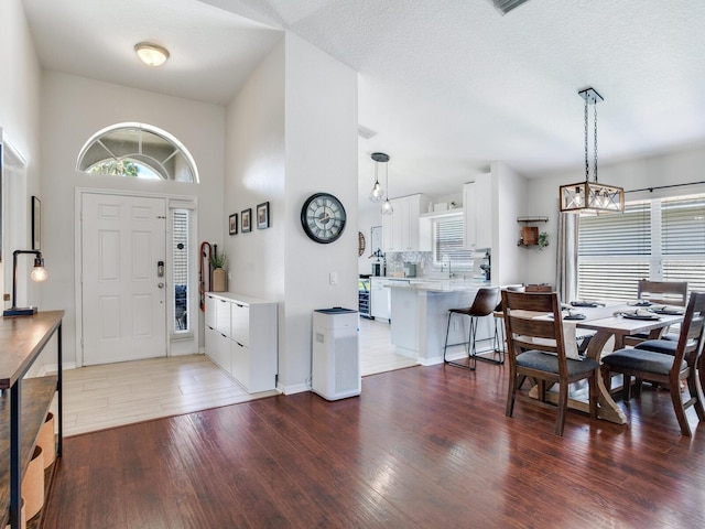 24811 Gun Smoke Dr, Land O Lakes, FL 34639 - entrance foyer with wood finished floors, healthy amount of natural light, and a chandelier