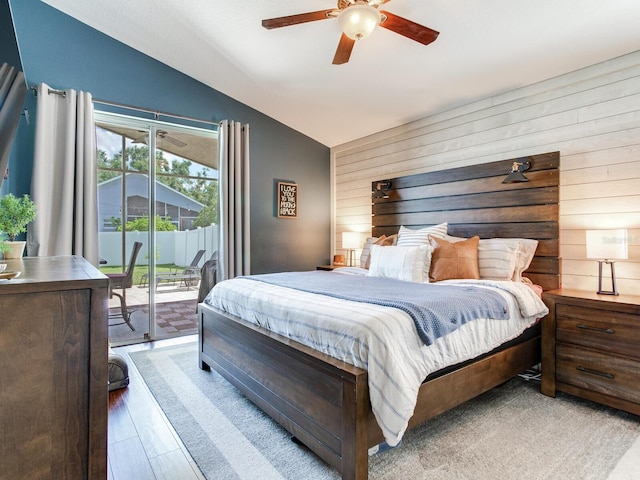 24811 Gun Smoke Dr, Land O Lakes, FL 34639 - bedroom featuring lofted ceiling, access to exterior, wooden walls, and a ceiling fan