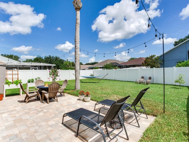 24811 Gun Smoke Dr, Land O Lakes, FL 34639 - fenced backyard featuring a patio area and an outdoor fire pit