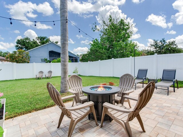 24811 Gun Smoke Dr, Land O Lakes, FL 34639 - fenced backyard featuring an outdoor fire pit and a patio