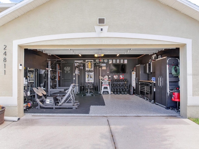 24811 Gun Smoke Dr, Land O Lakes, FL 34639 - garage featuring driveway and water heater