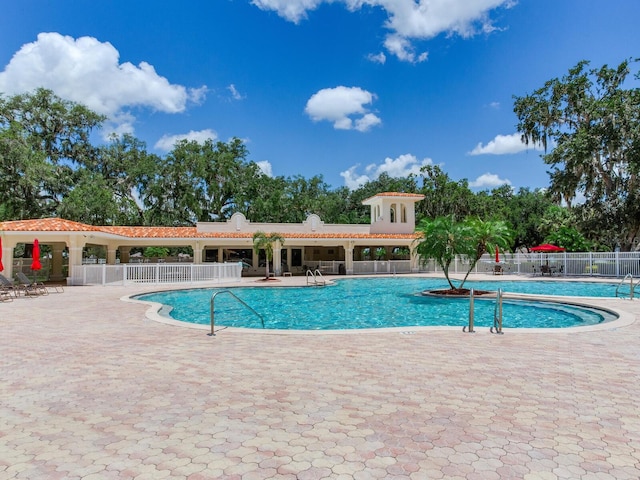 24811 Gun Smoke Dr, Land O Lakes, FL 34639 - community pool featuring a patio area