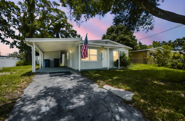 10215 N 23rd St, Tampa, FL 33612 - view of front of home with asphalt driveway, a carport, and a porch