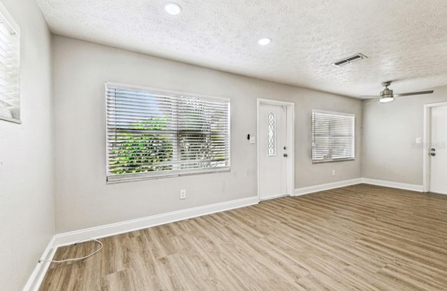 10215 N 23rd St, Tampa, FL 33612 - foyer with wood finished floors, a textured ceiling, ceiling fan, and recessed lighting