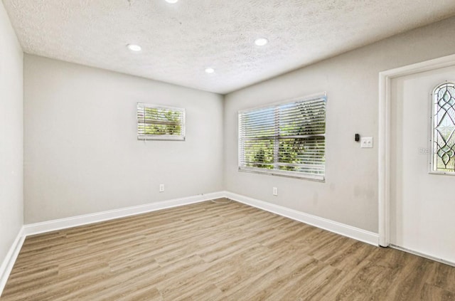 10215 N 23rd St, Tampa, FL 33612 - entrance foyer featuring wood finished floors, a textured ceiling, and recessed lighting