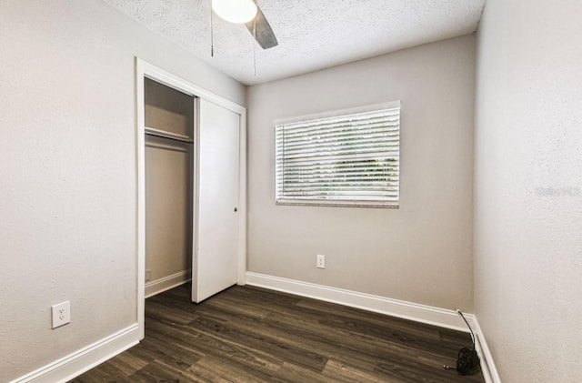 10215 N 23rd St, Tampa, FL 33612 - unfurnished bedroom featuring dark wood-style flooring, a closet, a textured ceiling, and ceiling fan