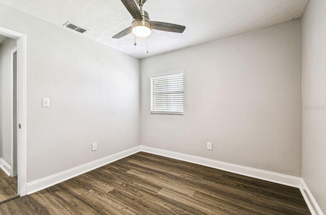 10215 N 23rd St, Tampa, FL 33612 - unfurnished room featuring dark wood-type flooring, a textured ceiling, and a ceiling fan