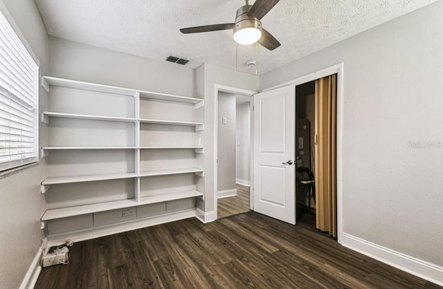10215 N 23rd St, Tampa, FL 33612 - unfurnished bedroom featuring dark wood-style floors, a textured ceiling, a ceiling fan, and a closet