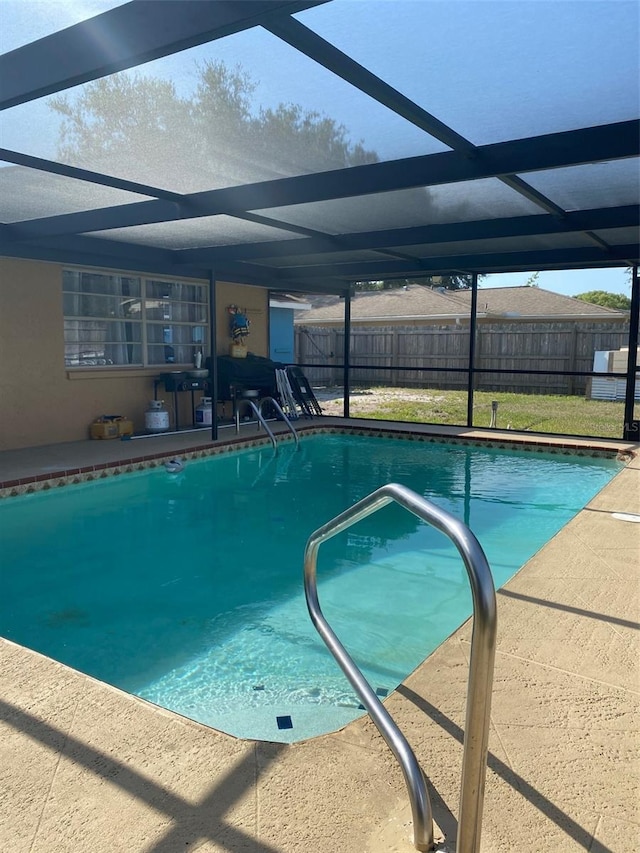 4219 Gray Squirrel Ln, New Port Richey, FL 34653 - view of swimming pool featuring glass enclosure and a patio area