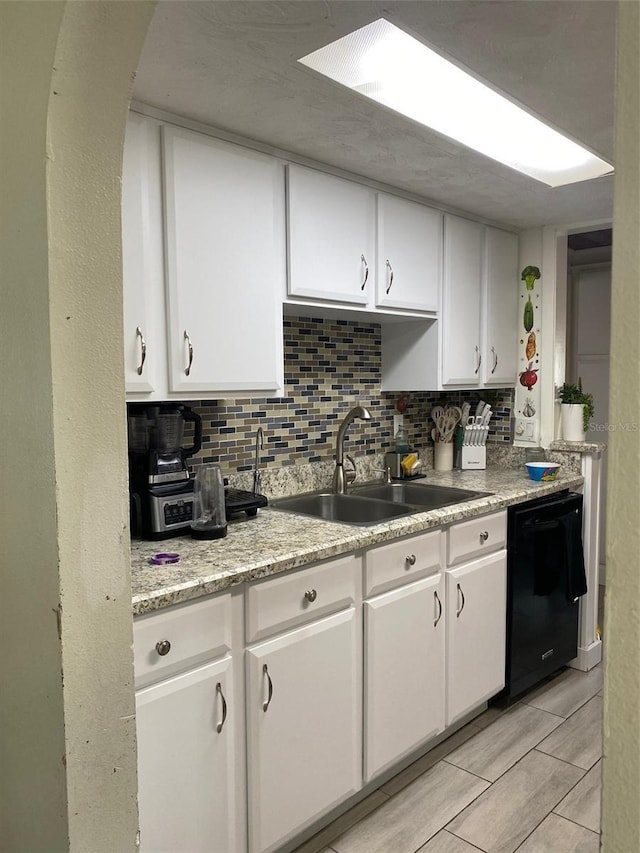 4219 Gray Squirrel Ln, New Port Richey, FL 34653 - kitchen with black dishwasher, white cabinetry, and decorative backsplash