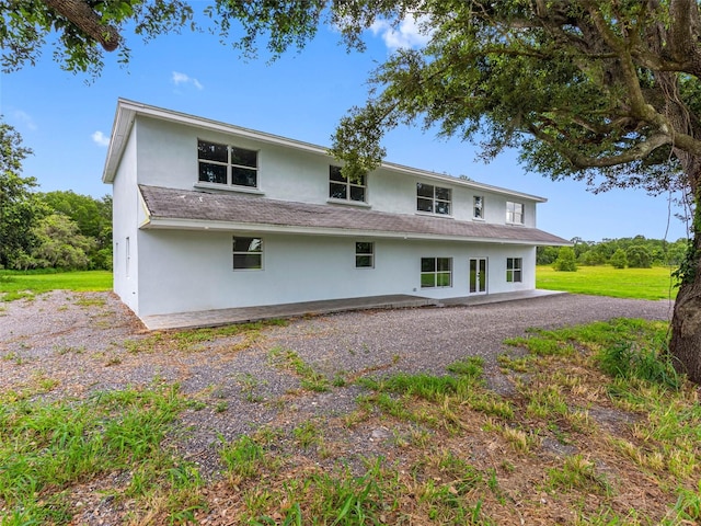 2440S Wallace Rd, Bartow, FL 33830 - back of house featuring stucco siding and a patio