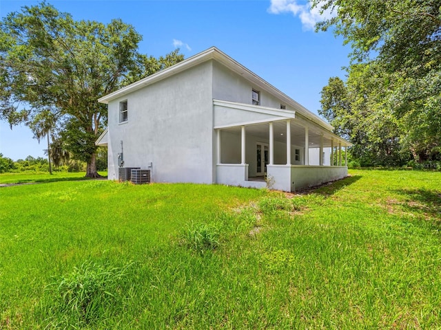 2440S Wallace Rd, Bartow, FL 33830 - back of house with stucco siding, a yard, and a sunroom
