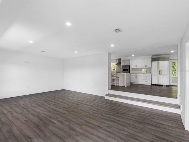 2440S Wallace Rd, Bartow, FL 33830 - unfurnished living room featuring dark wood-style flooring and recessed lighting