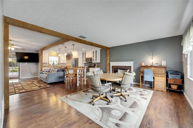 2914 Forest Cir, Seffner, FL 33584 - dining area featuring a fireplace, wood finished floors, a ceiling fan, and beam ceiling