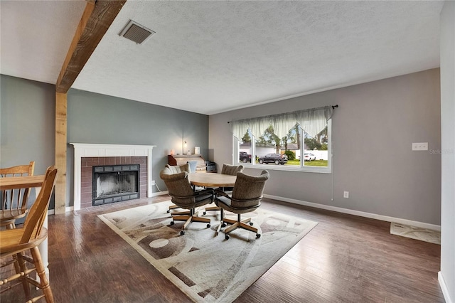 2914 Forest Cir, Seffner, FL 33584 - dining room with a brick fireplace, wood finished floors, and a textured ceiling