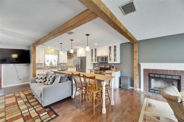 2914 Forest Cir, Seffner, FL 33584 - living area featuring beamed ceiling, dark wood-style floors, a fireplace, and recessed lighting